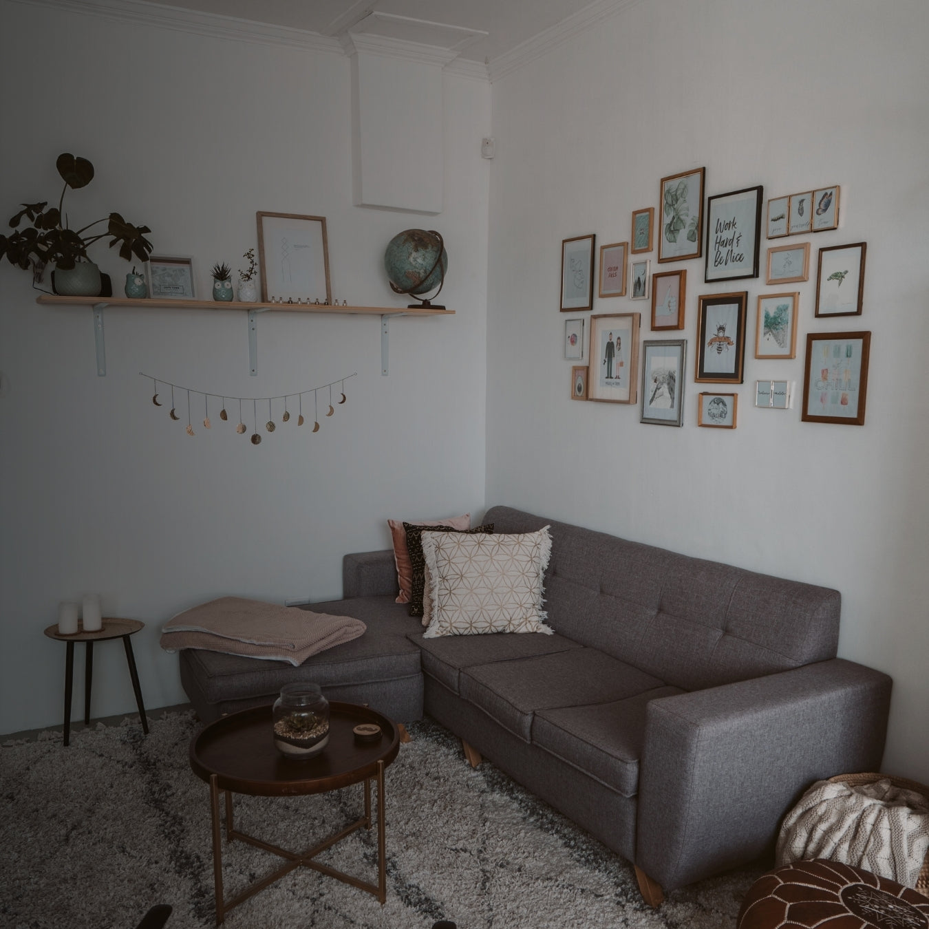 Living room with a gray sectional sofa, coffee table, and wall art.